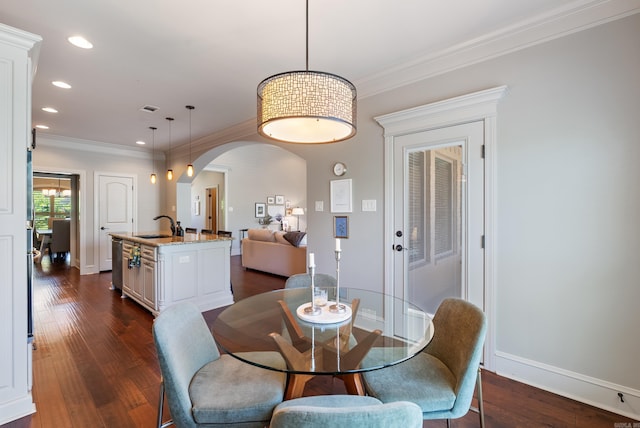 43 Tournay Cir, Little Rock, AR 72223 - dining space featuring arched walkways, dark wood-style flooring, crown molding, recessed lighting, and baseboards