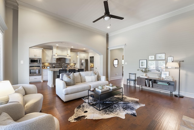 43 Tournay Cir, Little Rock, AR 72223 - living area featuring arched walkways, a ceiling fan, dark wood-style flooring, ornamental molding, and baseboards