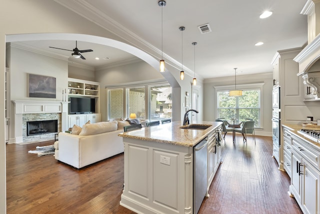 43 Tournay Cir, Little Rock, AR 72223 - kitchen with a sink, arched walkways, stainless steel appliances, light stone countertops, and crown molding