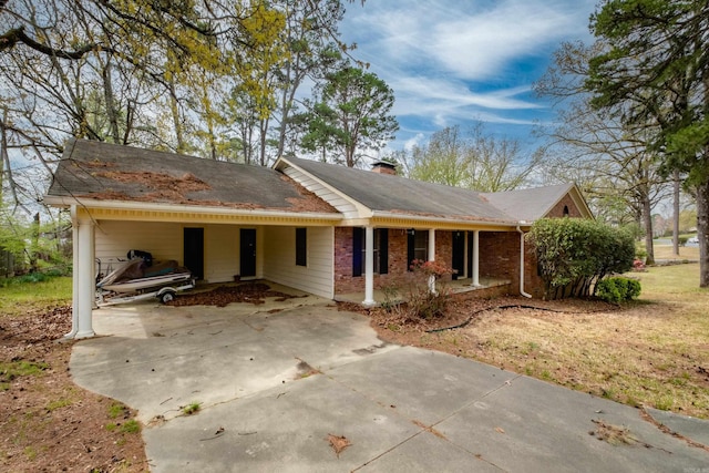17 Wingate Dr, Little Rock, AR 72205 - ranch-style home featuring concrete driveway, a carport, a chimney, and a porch