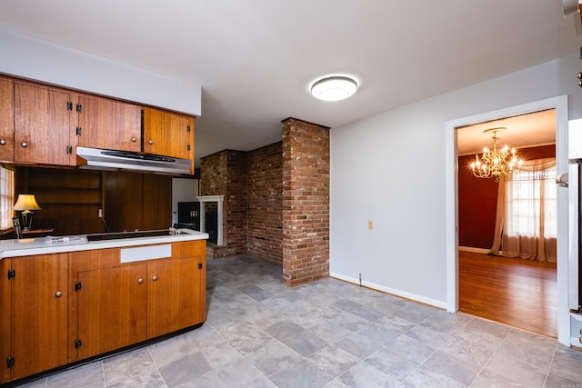 17 Wingate Dr, Little Rock, AR 72205 - kitchen with extractor fan, brown cabinetry, a chandelier, light countertops, and black electric stovetop