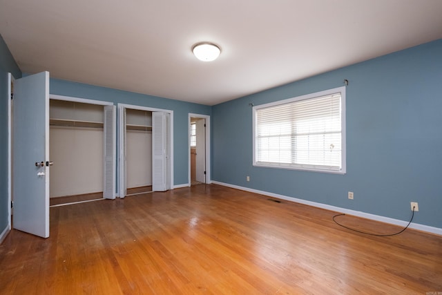 17 Wingate Dr, Little Rock, AR 72205 - unfurnished bedroom with multiple closets, baseboards, and wood finished floors
