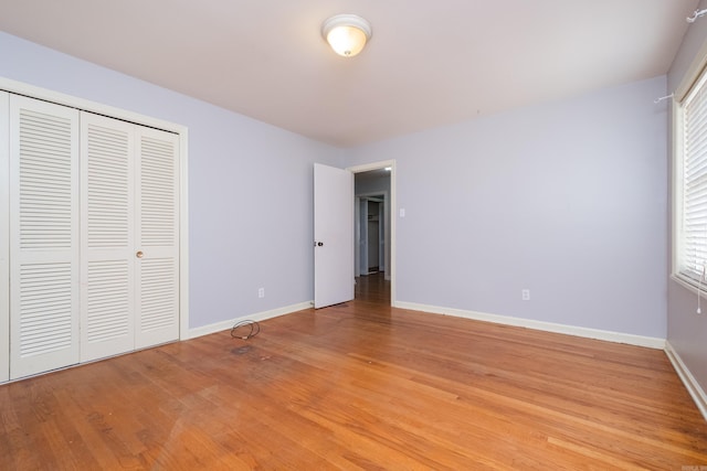 17 Wingate Dr, Little Rock, AR 72205 - unfurnished bedroom featuring baseboards, light wood finished floors, a closet, and multiple windows