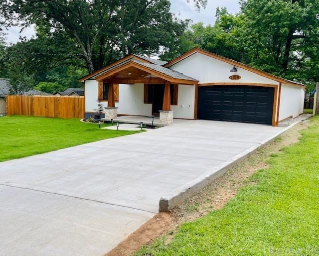 1108 Kenwood, Benton, AR 72019 - view of front of house with an attached garage, driveway, and stucco siding