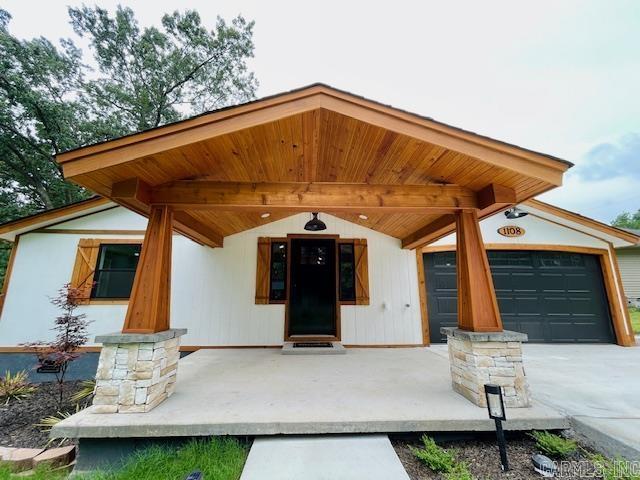1108 Kenwood, Benton, AR 72019 - property entrance featuring a garage and concrete driveway