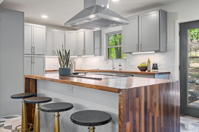 136 Buster Reed Dr, Hot Springs, AR 71913 - kitchen featuring island range hood, butcher block counters, a center island, tasteful backsplash, and recessed lighting