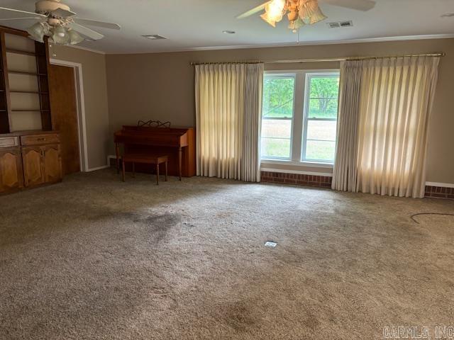 707 E Padgett, El Dorado, AR 71730 - living area featuring a ceiling fan, ornamental molding, carpet floors, and baseboards