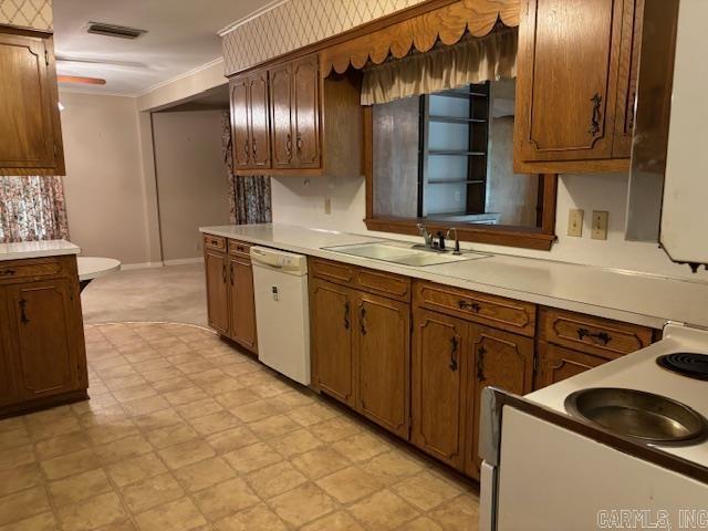 707 E Padgett, El Dorado, AR 71730 - kitchen with dishwasher, a sink, light floors, light countertops, and baseboards