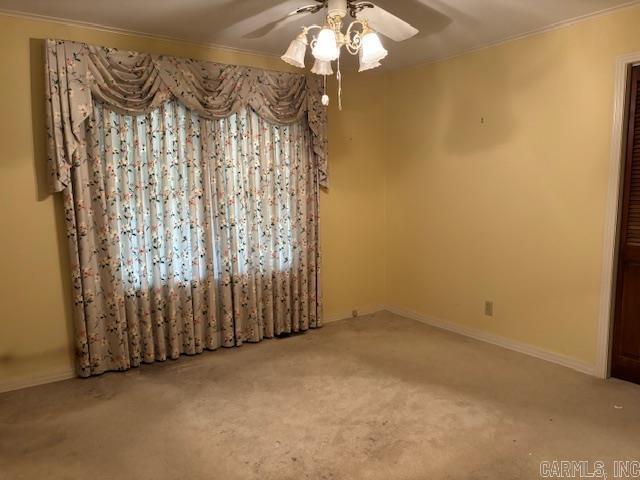 707 E Padgett, El Dorado, AR 71730 - unfurnished room featuring a ceiling fan, carpet flooring, ornamental molding, and baseboards