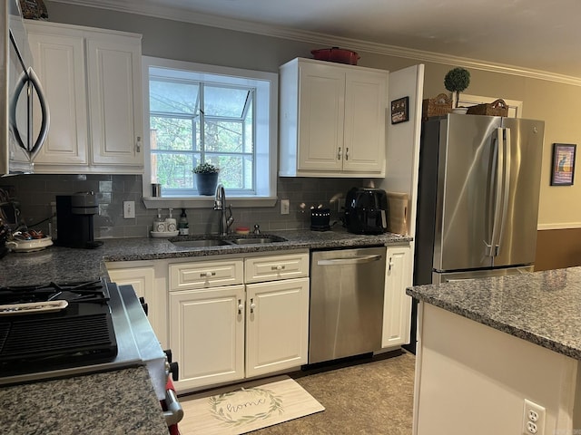 8 Evergreen Ct, Little Rock, AR 72227 - kitchen featuring stainless steel appliances, a sink, white cabinetry, decorative backsplash, and ornamental molding