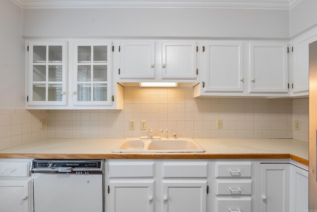 2805 Foxcroft Rd Unit 602, Little Rock, AR 72227 - kitchen featuring dishwasher, a sink, white cabinetry, decorative backsplash, and ornamental molding