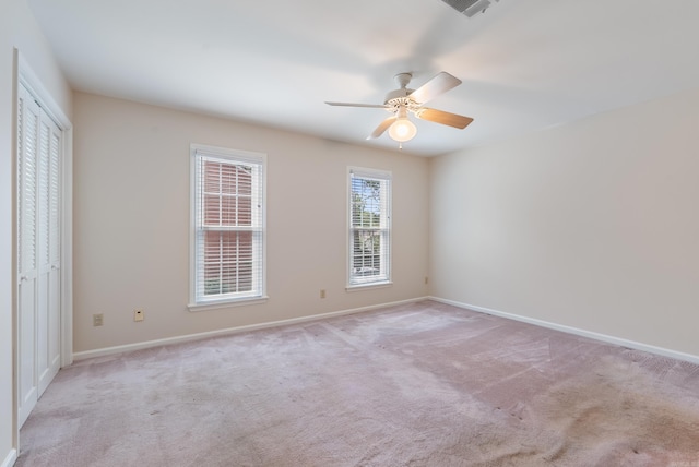 2805 Foxcroft Rd Unit 602, Little Rock, AR 72227 - unfurnished bedroom with light carpet, baseboards, ceiling fan, and a closet
