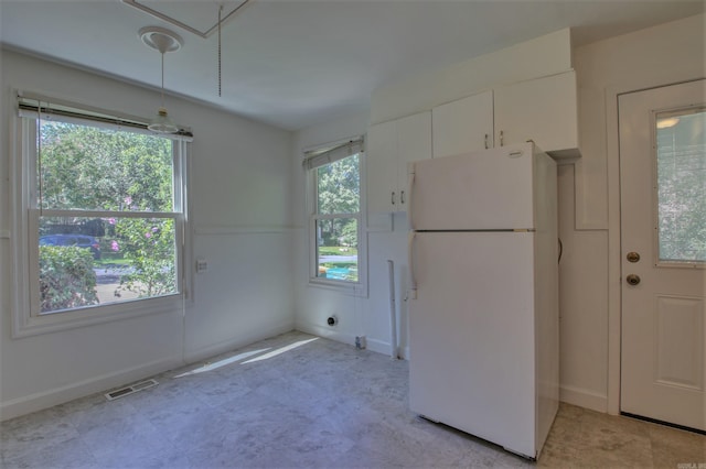 6800 Stamps Ct, Little Rock, AR 72207 - kitchen with freestanding refrigerator, white cabinets, and baseboards