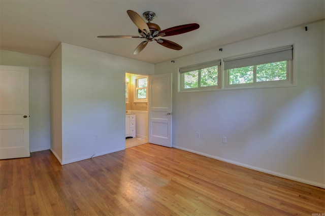 6800 Stamps Ct, Little Rock, AR 72207 - unfurnished bedroom with light wood-style flooring, baseboards, ensuite bath, and a ceiling fan