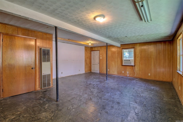 6800 Stamps Ct, Little Rock, AR 72207 - spare room featuring wooden walls, tile patterned floors, baseboards, cooling unit, and a textured ceiling