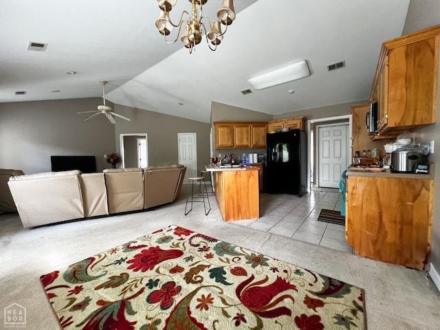 700 Amberwood, Jonesboro, AR 72401 - kitchen featuring black fridge, open floor plan, light carpet, brown cabinets, and vaulted ceiling