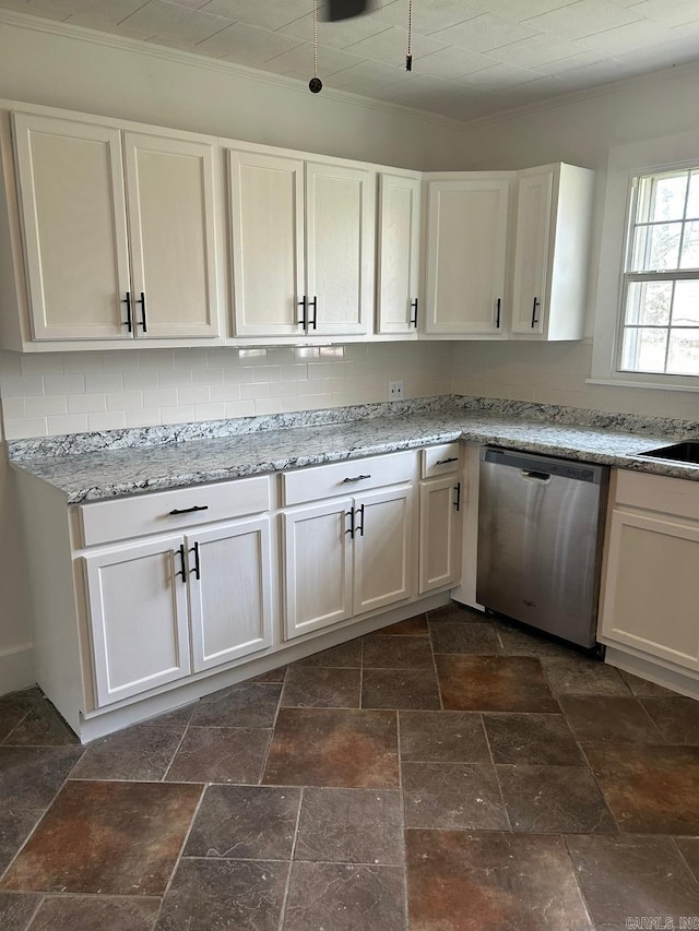 601 N Hickory, Searcy, AR 72143 - kitchen with stainless steel dishwasher, stone tile flooring, white cabinets, crown molding, and backsplash