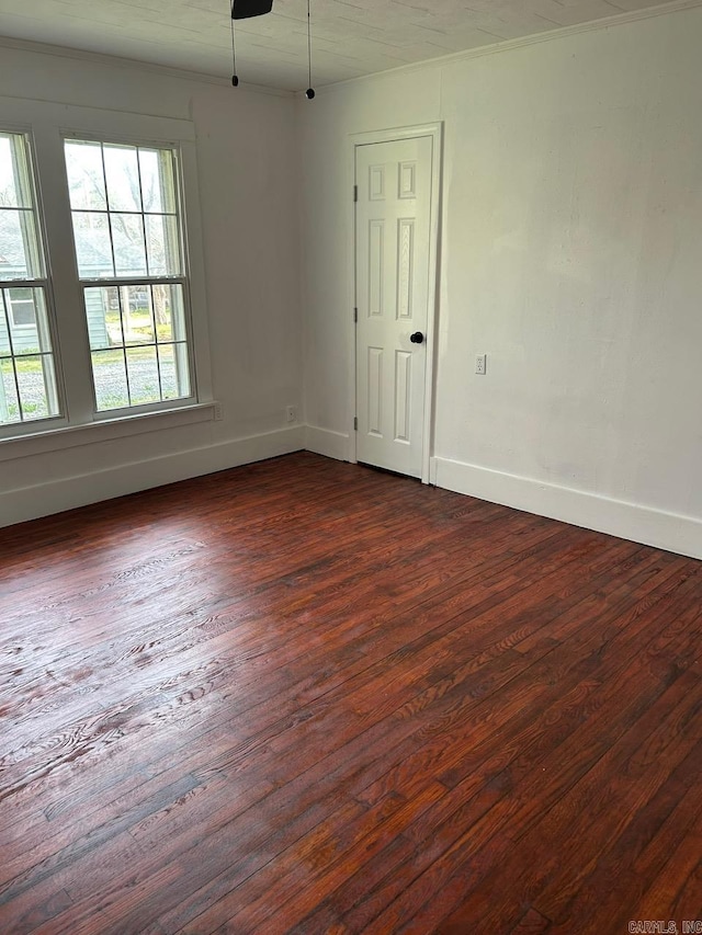 601 N Hickory, Searcy, AR 72143 - empty room with dark wood finished floors, baseboards, and ornamental molding