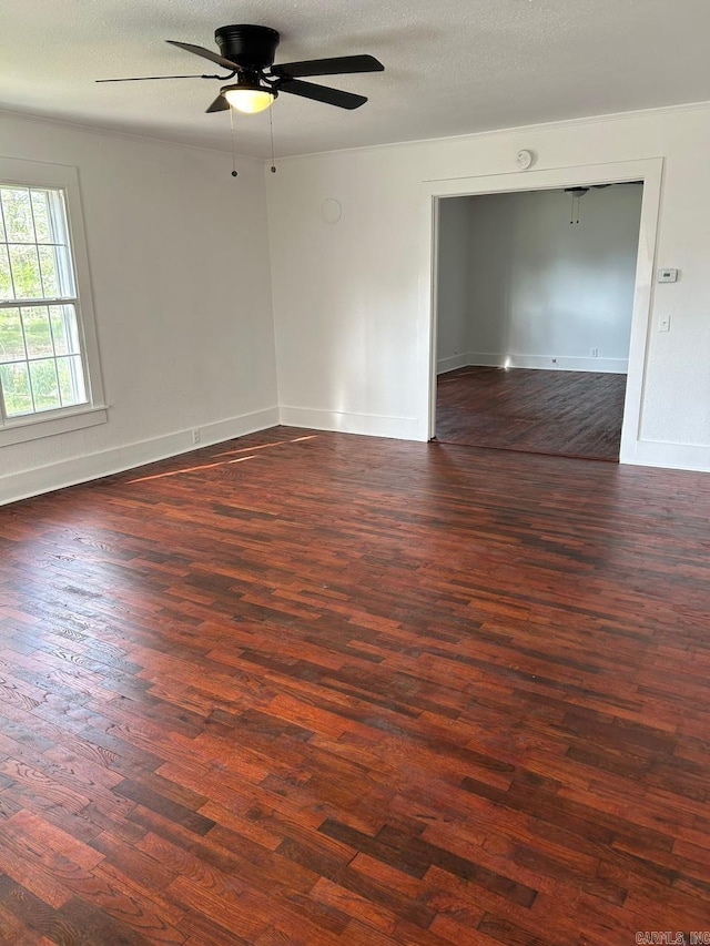 601 N Hickory, Searcy, AR 72143 - empty room with dark wood-style flooring, a ceiling fan, baseboards, and a textured ceiling
