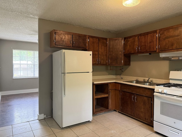 802 Desoto Pl, Benton, AR 72015 - kitchen with white appliances, under cabinet range hood, a textured ceiling, a sink, and light countertops