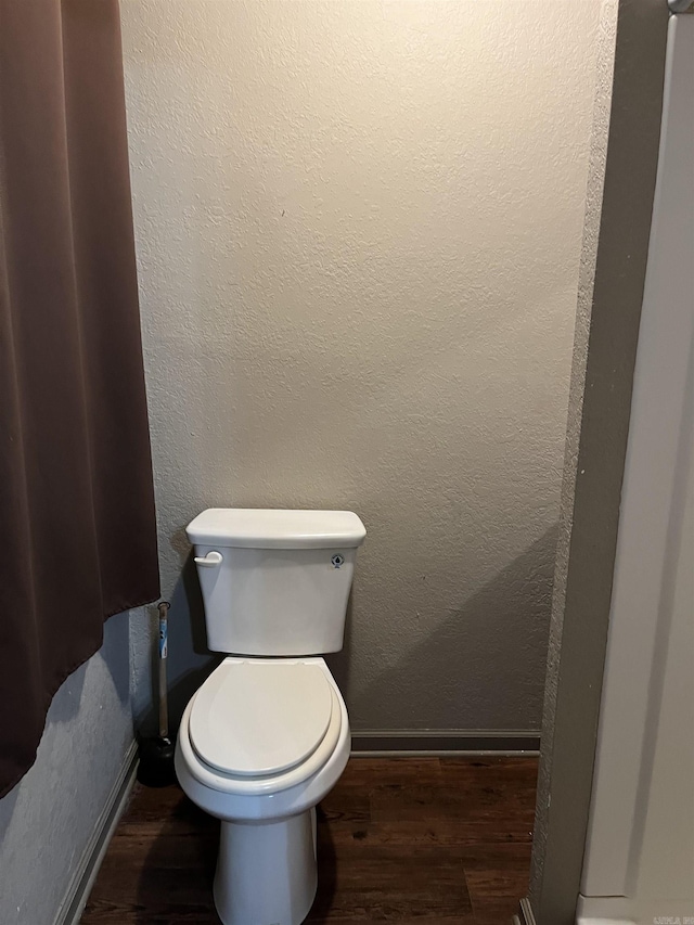 4903 Wise St, Paragould, AR 72450 - bathroom with wood finished floors, baseboards, and toilet