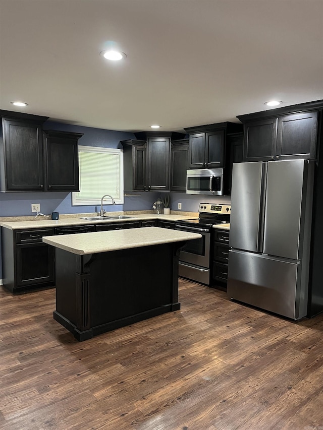 4903 Wise St, Paragould, AR 72450 - kitchen with appliances with stainless steel finishes, a sink, dark cabinetry, light countertops, and a center island