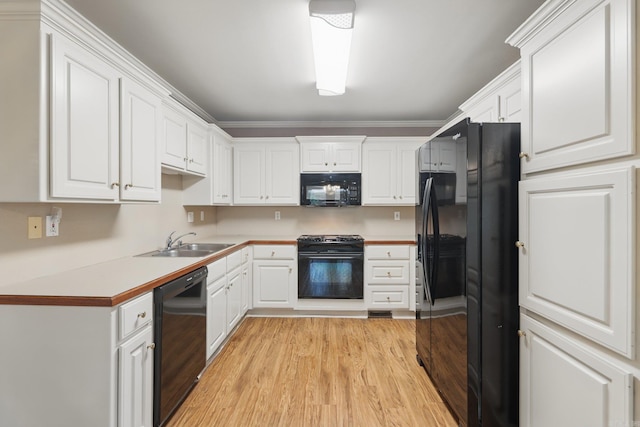 19 Golden Oaks Cv, Maumelle, AR 72113 - kitchen featuring black appliances, a sink, white cabinetry, and light wood-style flooring