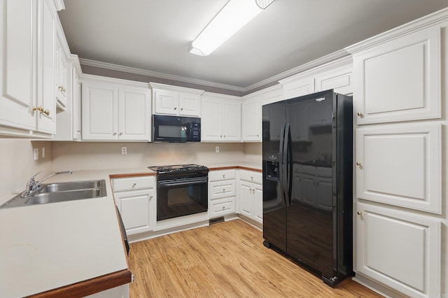 19 Golden Oaks Cv, Maumelle, AR 72113 - kitchen featuring black appliances, a sink, white cabinets, and light wood finished floors