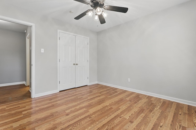 19 Golden Oaks Cv, Maumelle, AR 72113 - unfurnished bedroom with light wood-style flooring, baseboards, a closet, and a ceiling fan