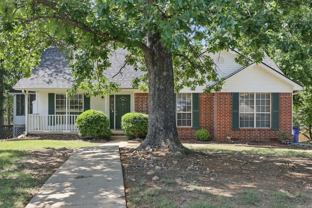 19 Golden Oaks Cv, Maumelle, AR 72113 - view of front facade with a porch, brick siding, and roof with shingles