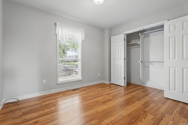 19 Golden Oaks Cv, Maumelle, AR 72113 - unfurnished bedroom with a closet, light wood-style flooring, and baseboards