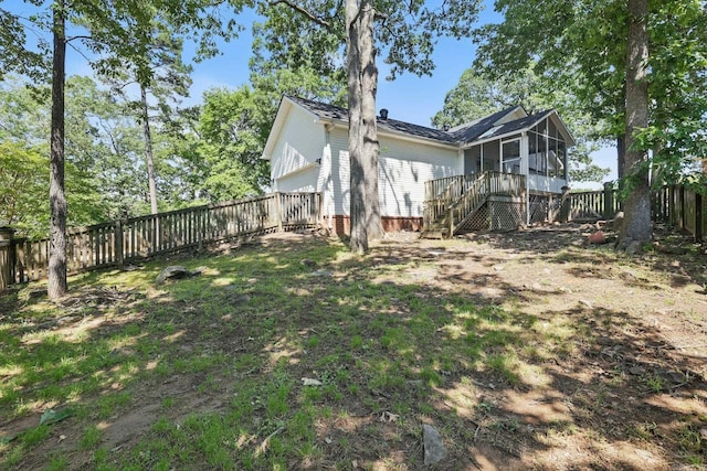 19 Golden Oaks Cv, Maumelle, AR 72113 - view of property exterior featuring a sunroom, stairway, a fenced backyard, and a garage