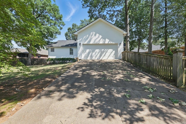19 Golden Oaks Cv, Maumelle, AR 72113 - view of property exterior featuring concrete driveway and fence