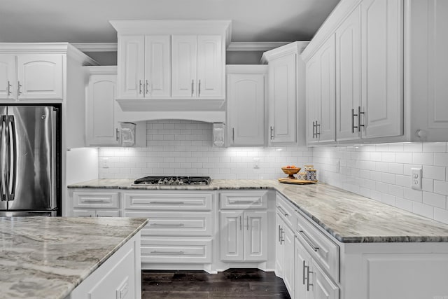 9224 Meadow Gardens Cir, Sherwood, AR 72120 - kitchen featuring appliances with stainless steel finishes, crown molding, white cabinetry, light stone counters, and dark wood-style floors