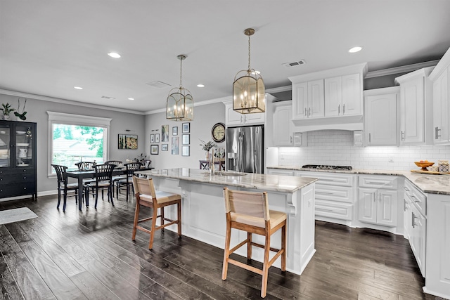 9224 Meadow Gardens Cir, Sherwood, AR 72120 - kitchen featuring appliances with stainless steel finishes, a sink, light stone counters, a chandelier, and white cabinetry