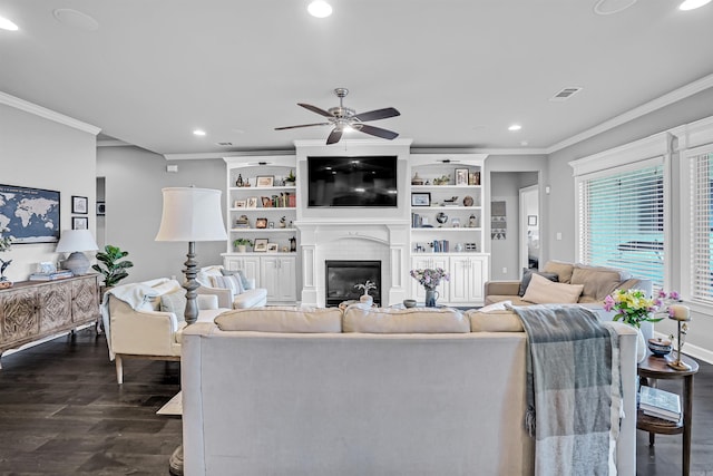 9224 Meadow Gardens Cir, Sherwood, AR 72120 - living area featuring dark wood-style flooring, recessed lighting, crown molding, ceiling fan, and a large fireplace