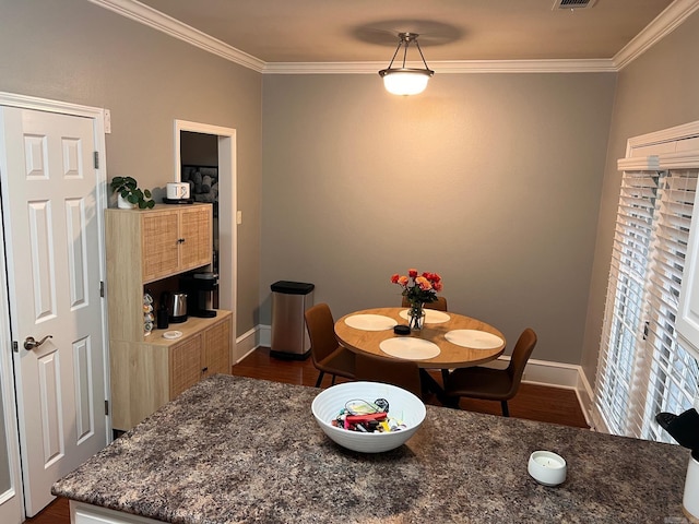 dining area with crown molding, dark wood-style floors, and baseboards