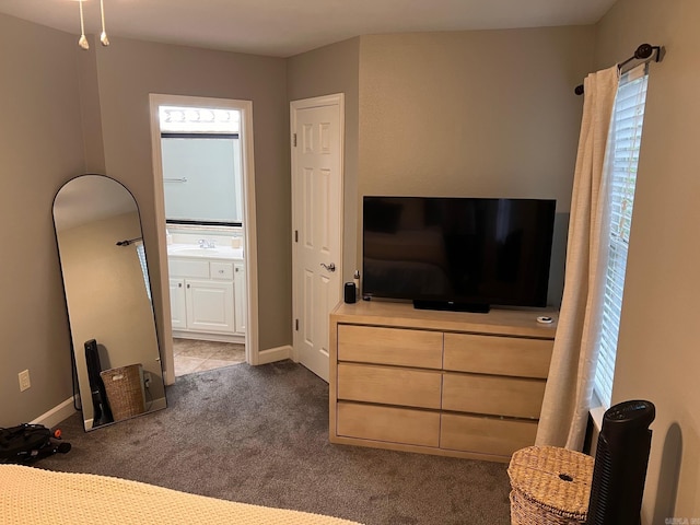 unfurnished bedroom with carpet floors, ensuite bathroom, and baseboards