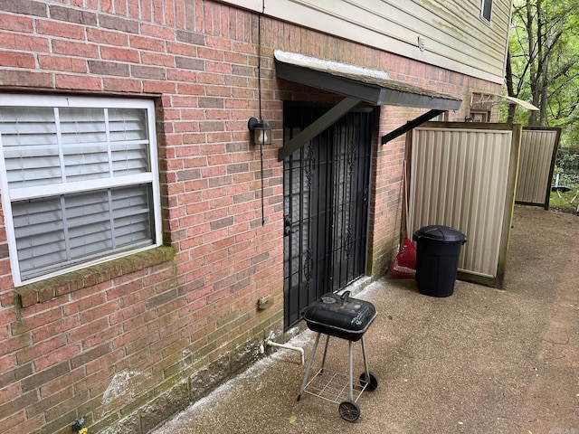 view of exterior entry with brick siding