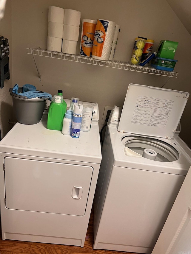 washroom featuring washer and clothes dryer and wood finished floors