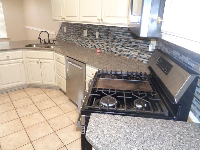 6 Jack Nicklaus Cv, Little Rock, AR 72210 - kitchen featuring stainless steel appliances, a sink, white cabinetry, tasteful backsplash, and light tile patterned floors
