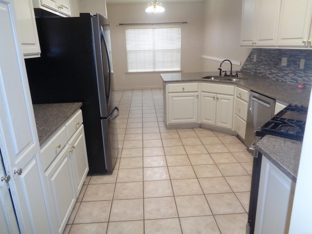 6 Jack Nicklaus Cv, Little Rock, AR 72210 - kitchen with a sink, freestanding refrigerator, light tile patterned floors, a peninsula, and white cabinets
