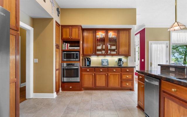 12 Sacedon Trce, Hot Springs Village, AR 71909 - kitchen with stainless steel appliances, brown cabinets, glass insert cabinets, and hanging light fixtures