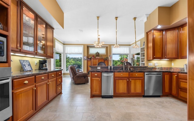 12 Sacedon Trce, Hot Springs Village, AR 71909 - kitchen with appliances with stainless steel finishes, a sink, a peninsula, brown cabinets, and crown molding
