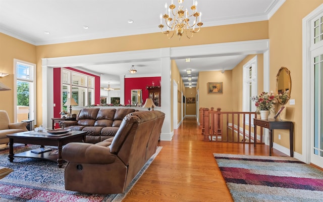 12 Sacedon Trce, Hot Springs Village, AR 71909 - living room with a chandelier, light wood-style flooring, crown molding, and baseboards