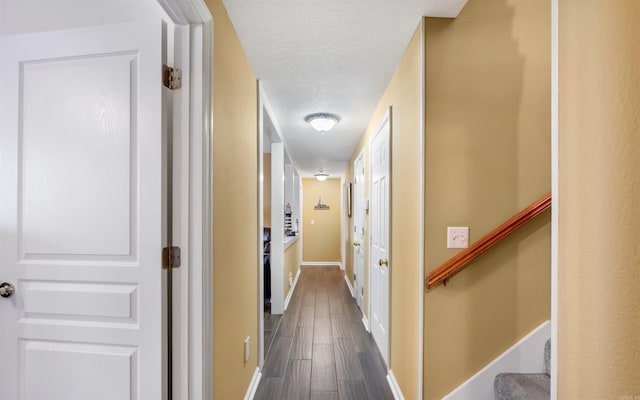 12 Sacedon Trce, Hot Springs Village, AR 71909 - corridor featuring dark wood-style floors, a textured ceiling, baseboards, and stairway