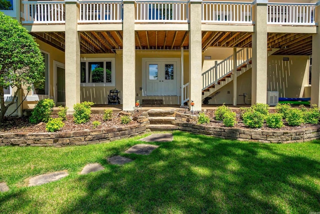 12 Sacedon Trce, Hot Springs Village, AR 71909 - doorway to property with stucco siding, a lawn, and a deck