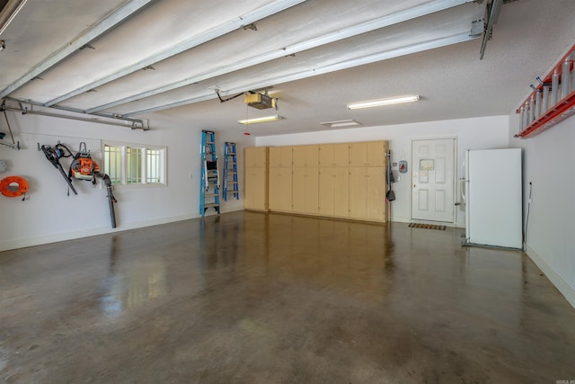 12 Sacedon Trce, Hot Springs Village, AR 71909 - garage with freestanding refrigerator, baseboards, and a garage door opener