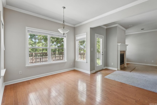 113 Shady Dr, Maumelle, AR 72113 - unfurnished living room featuring baseboards, hardwood / wood-style flooring, crown molding, and a fireplace with flush hearth