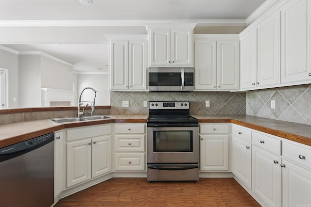 113 Shady Dr, Maumelle, AR 72113 - kitchen with stainless steel appliances, a sink, ornamental molding, white cabinetry, and backsplash